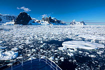 Peaks on the side of Lemaire Channel between Booth Island and Kiev Peninsula, view above from bow of expedition cruise ship. Antarctica. December 2019.