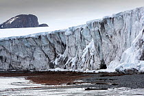 Edge of retreating glacier, shore below. Livingston Island, South Shetland Islands, Antarctica. December 2019.