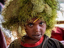 Boy at a welcome ceremony wearing headdress made from Lichen, portrait. Kiowe, Eastern Highlands, Papua New Guinea.
