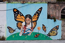Mural of girl with Monarch butterfly (Danaus plexippus) wings in Agangeo town, near to Monarch butterfly reserve, Mexico.