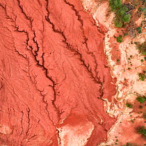 Red mud deposits, with cracks forming. Red mud / alumina storage facility . Alumina is a highly alkaline waste product from the aluminium industry.