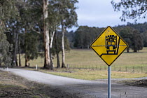 Logging truck warning sign beside road, Bendoc, East Gippsland, Victoria, Australia.