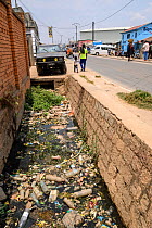 Plastic litter including bottles in gutter. Mandroseza, Antananarivo, Madagascar. 2019.