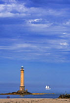 Phare de La Hague / Phare de Goury lighthouse and two-master sailing ship near Auderville, Cap de La Hague, Cotentin peninsula, Lower Normandy, France. August 2020
