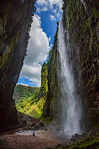 Angel Falls, the world&#39;s highest uninterrupted waterfall with a fall of 807m, flowing from Auyan-tepui, a table-top mountain. Helicopter used in filming at base of waterfall with people beside it....