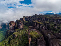 People alongside helicopter with film camera mounted, on tepui table-top mountain, aerial view. Taken on location for BBC Seven Worlds One Planet series. Canaima National Park, Venezuela. 2018.