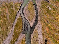 Glacier fed braided river through King penguin (Aptenodytes patagonicus) breeding colony, aerial view. St Andrews Bay, South Georgia. October 2017.