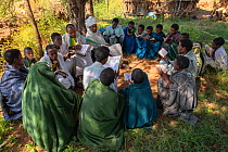 Priests teaching students in forest of Wagira Maryam Orthodox Church. Near Hamusit, Ethiopia. 2018.