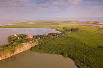 Aerial view of monastery surrounded by church forest on shore of Lake Tana, with river estuary beyond. Church forests remain largely intact in a degraded landscape as they are considered sacred. Near...