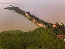 Aerial view of monastery surrounded by church forest on shore of Lake Tana, Tana Qirgos Island in distance. Church forests remain largely intact in a degraded landscape as they are considered sacred....