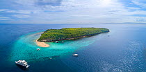 Aerial view of the sand bar and reef off the corner of Sumilon Island, a tiny island off the coast of Bancogon, Cebu, Philippines. A live-aboard scuba diving vessel is moored just offshore.