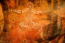 Aboriginal rock art depicting Nabulwinjbulwinj, a dangerous spirit that eats females after striking them with a yam. Kakadu National Park, Northern Territory, Australia.