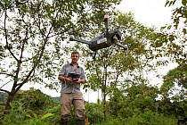 Botanist Dr. Anton Weissenhofer using a drone to survey, part of tropical rainforest regeneration project. Golfito, Costa Rica. 2018.