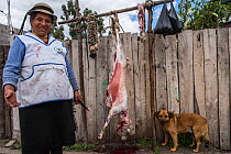 Local woman butchering sheep, Chimborazo Province, Andes, Ecuador. July 2016.
