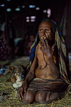 Dani tribe woman smoking. Budaya village, Suroba, Trikora Mountains, West Papua, Indonesia. March 2018.