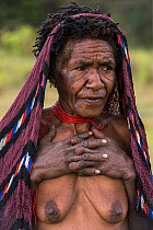 Dani tribe woman. Her fingers were removed after the death of a relative. First crushed with a stone then cut off. Budaya village, Suroba, Trikora Mountains, West Papua, Indonesia. March 2018.