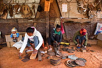 Deaf workers, in metal factory, making metal artefacts for tourist industry, Antananarivo, Madagascar. October 2018.
