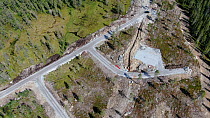 Aerial shot of a mountain area newly opened with road construction for housing development, threatening the mountain landscape, Viken, Norway, August.