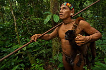 Huaorani Indian, Tage Kaiga, hunting in Amazon rainforest, dead Woolly monkey (Lagothrix sp) slung over shoulder, shot using blowgun. Members of this Indian tribe were uncontacted until 1956. Yasuni N...