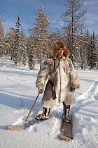 Selkup man, Kosta, hunting in snow covered forest, on skis. Krasnoselkup, Yamal, Western Siberia, Russia.