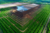 Aerial view of coal ash pyramid in East-Central Europe. After coal is burned in power plants, the waste ash is stacked layer-by-layer and compacted into large pyramids, which may eventually be covered...
