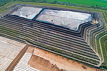 Aerial view of coal ash pyramid in East-Central Europe. After coal is burned in power plants, the waste ash is stacked layer-by-layer and compacted into large pyramids, which may eventually be covered...