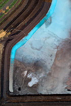 Aerial view of ash pond in East-Central Europe. After coal is burned in power plants, the waste ash is mixed with water and pumped through pipelines into sludgy lagoons commonly known as ash ponds. Th...