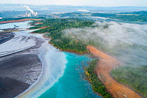 Aerial view of ash pond near coal power plant visible in the background, Bosnia and Herzegovina. After coal is burned in power plants, the waste ash is mixed with water and pumped through pipelines in...
