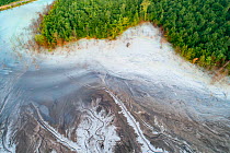 Aerial view of ash pond on the edge of a forest, Bosnia and Herzegovina. After coal is burned in power plants, the waste ash is mixed with water and pumped through pipelines into sludgy lagoons common...
