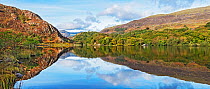 Reflections in Llyn Dinas on a still morning in the Nant Gwynant valley near Beddgelert, Snowdonia, North Wales, UK October 2018