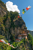 Paro Taktsang / Tiger&#39;s Nest Buddhist monastery on cliff and prayer flags. Bhutan. September 2013.