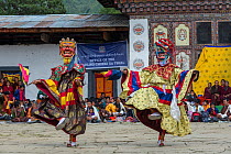 Cham or &#39;Mask&#39; Dancers at Gante Goemba Tsechu, festival in monastery courtyard. Phobjika, Bhutan. September 2013.