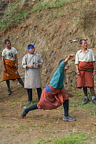 Men playing with wooden darts known as khuru, played during festivals. Bhutan. September 2013.