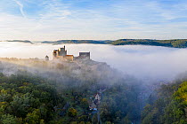 Beynac Castle in the mist, Beynac-et-Cazenac Village, Dordogne, France, October 2020.