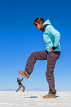 Forced perspective photo of a giantwoman in the saltflats of Salar de Uyuni, Bolivia.