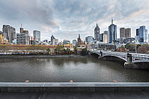View of Melbourne city from the Southbank side of the Yarra River in the early morning. Princes Bridge is on the right and historic Flinders Street train station directly across. Southbank, Melbourne,...