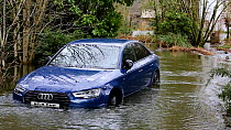 Car partially submerged underwater due to flooding caused by Storm Ciara, Rothay Bridge, Ambleside, Lake District, UK, February, 2020.