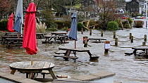Outdoor tables in Wateredge Hotel beer garden partially submerged underwater due to flooding after Storm Ciara at Lake Windermere, Ambleside, Lake District, UK, 2020.