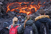 Icelandic people watching and photographing lava at the eruption site, Fagradalsfjall volcano, Iceland, 2 April 2021.  The volcano has drawn an estimated number of 30.000 visitors since the start of...