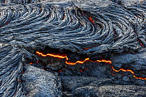 Close-up of solidified lava and fluid lava underneath, taken at the edge of the lava field at the Fagradalsfjall volcano, Iceland, 4 April 2021.