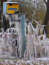 Speed camera covered in icicles from splashed flood water, Hertfordshire, England, UK, February