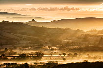 Frosty winter sunrise from Lambert&#39;s Castle looking across the Marshwood Vale towards Colmer&#39;s Hill, The Fleet and Chesil Beach, Dorset, England, UK. January 2021
