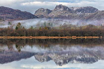 The Langdale Pikes reflected in Elter Water, Lake District National Park, Cumbria, England, UK. December 2020