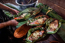 Local river fish traditionally prepared and steamed in banana tree leaves by the Anangu community. Napo Cultural Center Lodge, Yasuni National Park, Ecuador.