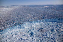 Aerial view of the front of the Sermeq Kujalleq Glacier, Greenland, entering the Kangia Ilulissat Icefjord full of icebergs. The icebergs are produced by the Sermeq Kujalleq Glacier, one of the fastes...