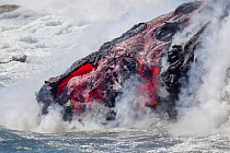 The Pahoehoe lava flowing from Kilauea into the Pacific ocean near Kalapana, Big Island, Hawaii.