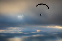 Paraglider over Ringstead Bay with Portland beyond, Jurassic Coast, Dorset, England, UK. December 2019.