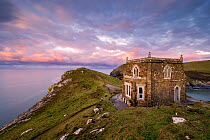 Doyden Castle, a little fortress at the edge of the cliffs on the Port Quin headland, at sunset. This small cove and hamlet is situated between Port Isaac and Polzeath in north Cornwall, UK. January 2...