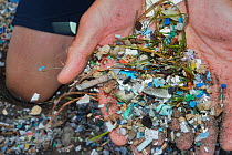 Person holding plastic and microplastics from the beach, brought in by the winds and the tides, Canary Islands.