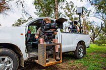 Film crew with their specially modified vehicle for filming Servals at night, South Africa, 2016. On location for BBC &#39;Big Cats&#39;